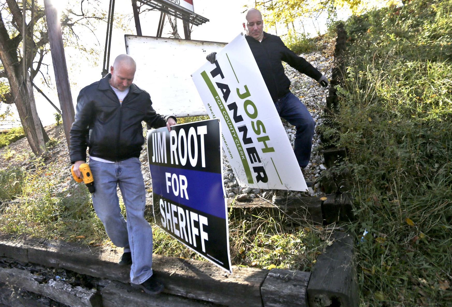 Jim Root and Josh Tanner picking up signs